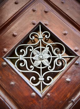 Metal ornamental pattern with leaves in wooden frame