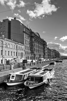 Boats parking in city channel, vintage photo style