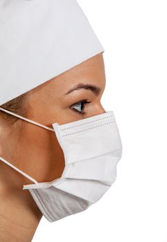 Profile of a young woman surgeon wearing a mask.