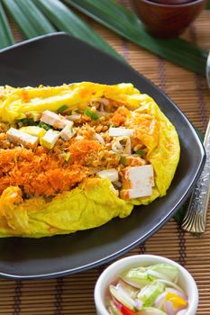 Stir fried tofu,bean sprout,turnip and coconut wrapped in omelet by cucumber and vinegar dip sauce  [Thai's food ]