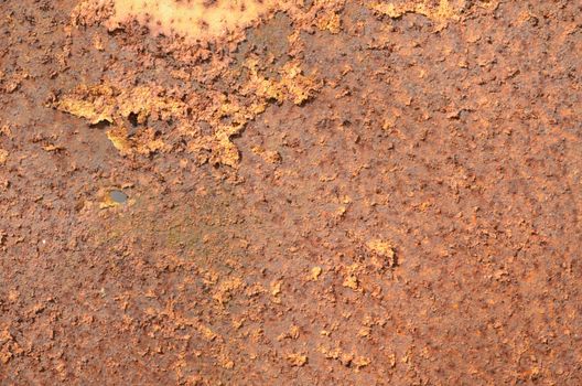 Background of rusty peeling paint steel wall texture. Time and corrosion affected surface.