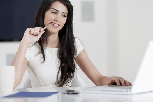 Young woman working at her desk in the office