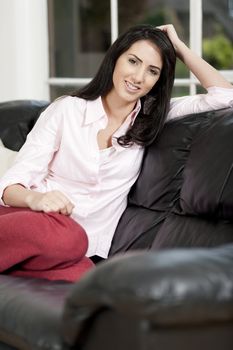 Young woman lying on sofa at home