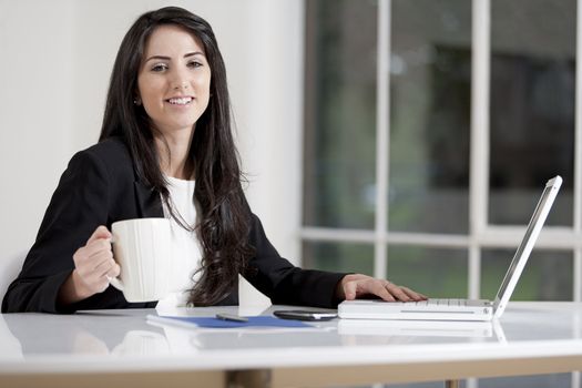 Young woman working at her desk in the office