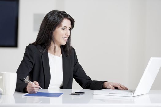 Young woman working at her desk in the office