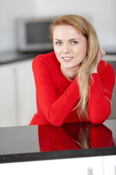 Young woman relaxing in the kitchen at home