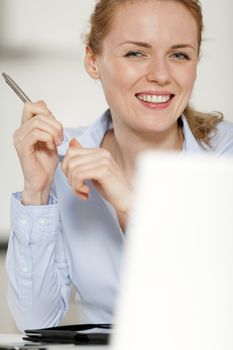 Young woman working at her desk in the office