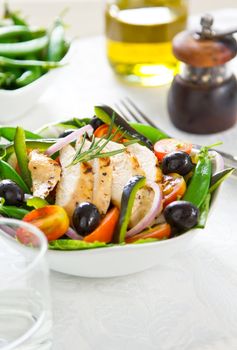 Grilled chicken with pea ,black olive and pepper salad