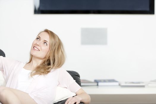 Young woman lying on sofa at home