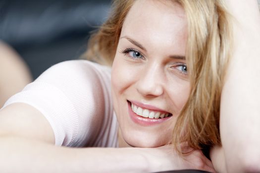 Young woman lying on sofa at home