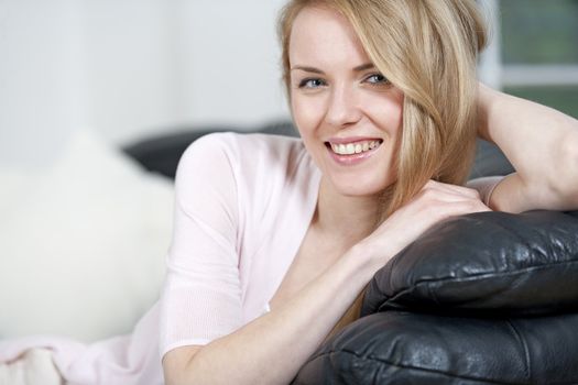 Young woman lying on sofa at home