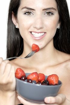 Beautiful young woman enjoying fresh fruit for breakfast