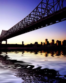 Beautiful historical Crescent City Connection Bridge in New Orleans Louisiana. Skyline, cityscape with reflection in water.