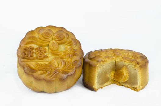 Mooncake cutted with lotus seed paste and yolk inside, isolated white background