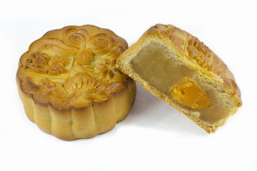 Mooncake cutted with lotus seed paste and yolk inside, isolated white background