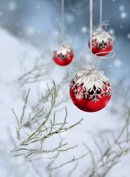 Red Christmas balls in beautiful winter snowfall fantasy