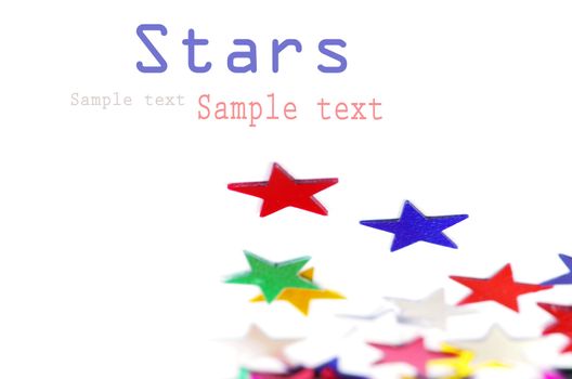 Christmas decoration of colored confetti stars against white background