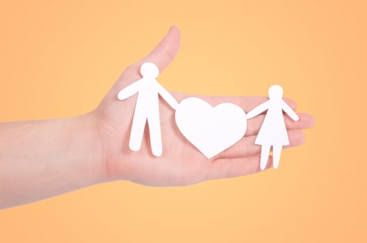 paper family in hands isolated on white