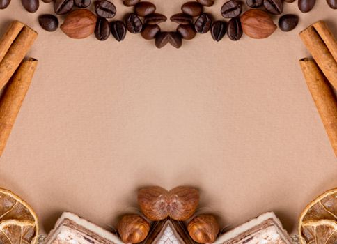 Close up of coffee, cinnamon, nuts, sweet on old paper material. Place for text.