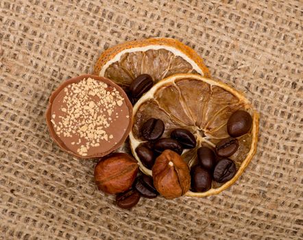 Sweet, lemon, nuts and coffee beans on burlap