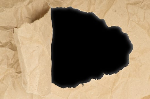 ripped white paper against a black background