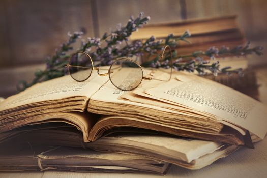 Old books open on a wooden table 