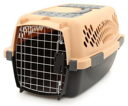 Clean empty unused pet carrier with door over white background.