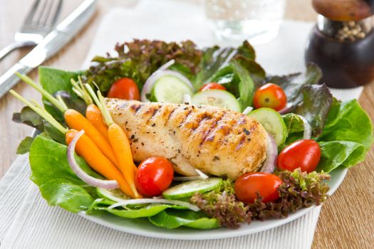 Grilled chicken with lettuce,cherry tomato and baby carrot salad
