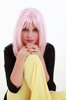 Young woman with pink hair on the floor