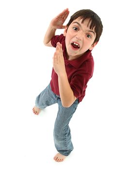 Adorable 8 year old french american boy making silly karate faces and poses over white background.