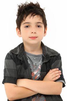 Attractive eight year old portrait of boy with stylish hair over white arms crossed.