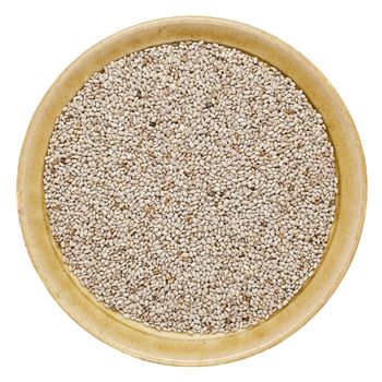 white chia seeds  in a round ceramic bowl isolated on white