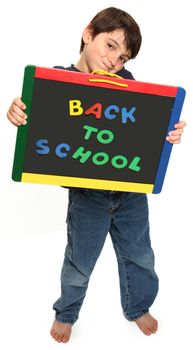 adorable seven year old boy holding Back To School chalk board