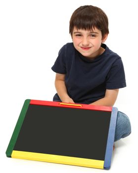 adorable seven year old boy holding blank chalkboard