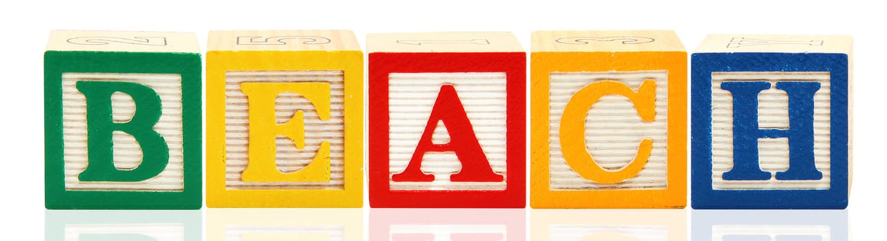 Colorful alphabet blocks. spelling the word beach.