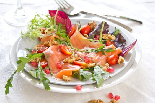 Smoked salmon with pomegranate,walnut and rocket salad