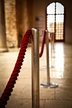 Red barrier rope on window background. event object