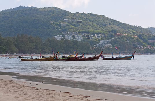 Boats on  shore waiting for tourists, Thailand.