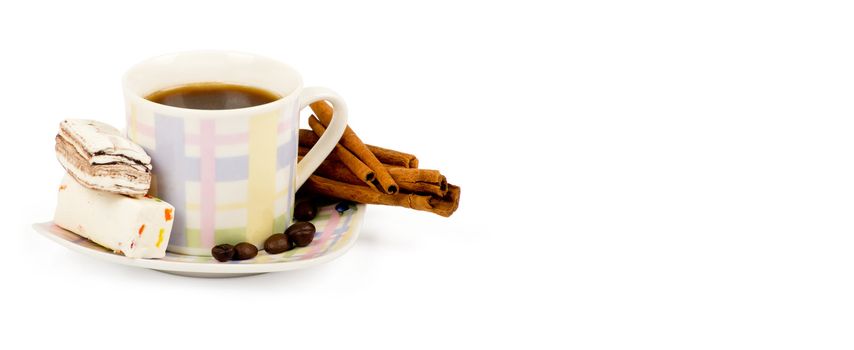 Coffee cup with sweets an cinnamon on white background
