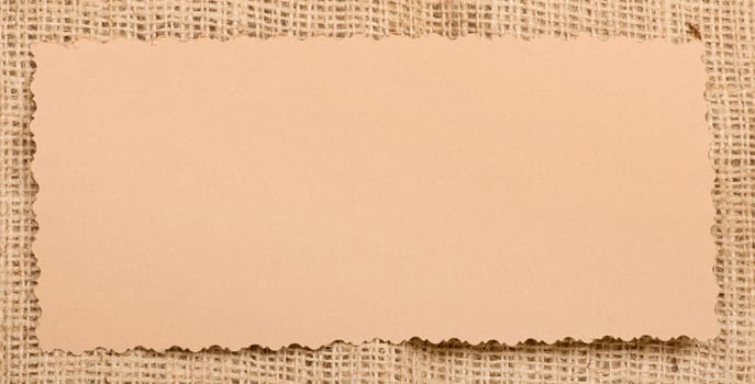 Old paper tag on natural burlap