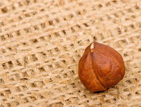 Hazelnuts on burlap background