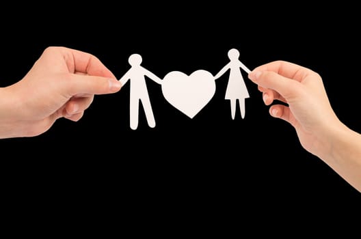 paper family in hands isolated on black background