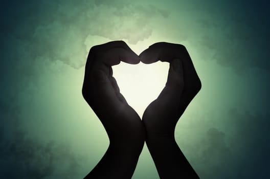 love shape hand silhouette in sky