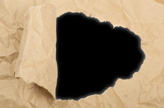 ripped white paper against a black background