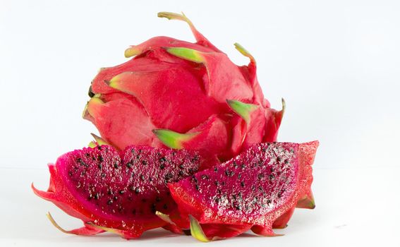 Healthy red dragon fruit against white background