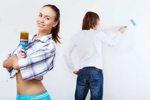 Portrait of young couple with paint brushes