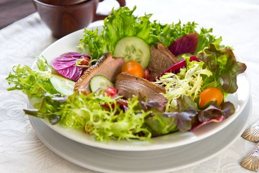 Smoked duck with lettuce,cherry tomato and pomegranate salad