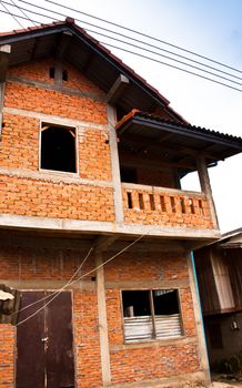 House under construction. The brick wall is being installed.