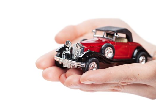 Closeup view of toy car in woman hands isolated over white background