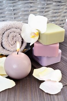 Spa and wellness setting with natural soap, candles and towel. Beige dayspa